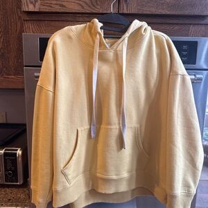 Woman’s Yellow Hoodie. Hombre drawstring accent. Slightly cropped.